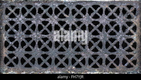 Ornate cast iron ventilation brick on an external church wall Stock Photo