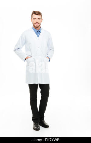 Full length portrait of a young male doctor standing and looking at camera isolated on a white background Stock Photo