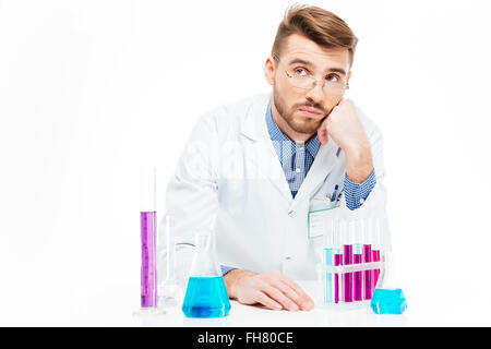 Scientist pouring chemicals isolated on a white background Stock Photo