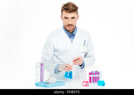 Scientist doing experiments with rat in a laboratory Stock Photo