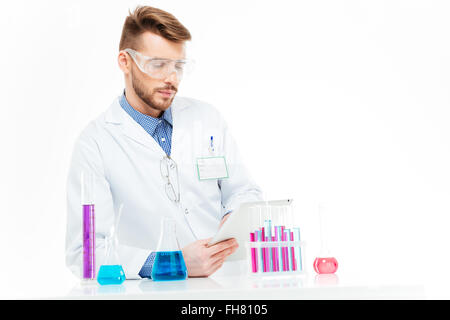 Chemist using tablet computer in laboratory Stock Photo