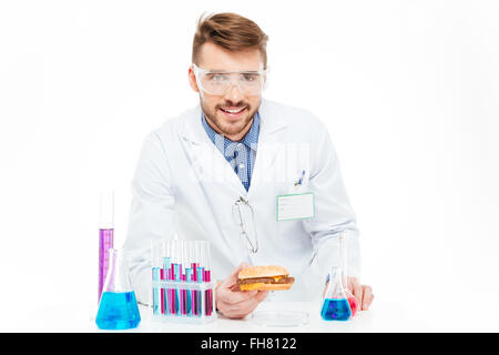 Male chemist making GMOs food isolated on a white background Stock Photo