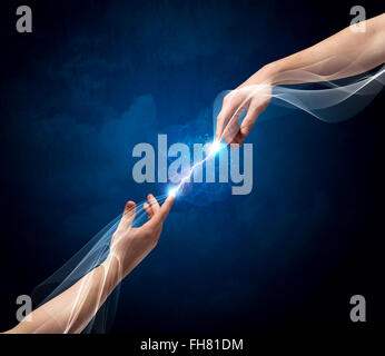 Hands connecting through fingers in space Stock Photo