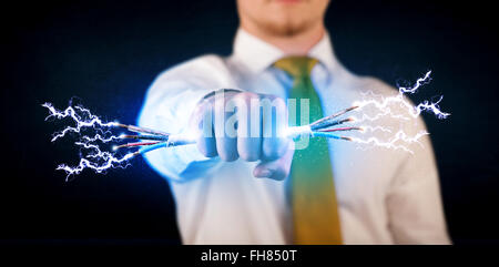 Business person holding electrical powered wires Stock Photo