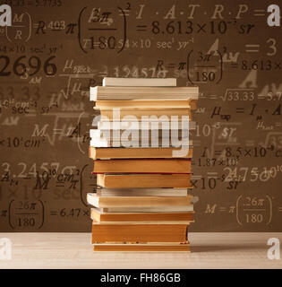 Books on vintage background with math formulas Stock Photo