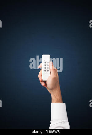 Hand with remote control Stock Photo
