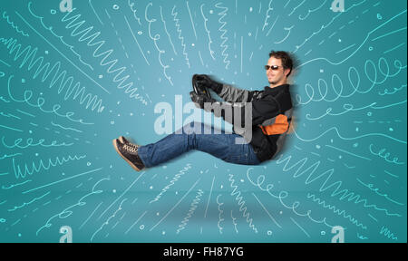 Funny guy drives an imaginary vehicle with drawn lines around him Stock Photo