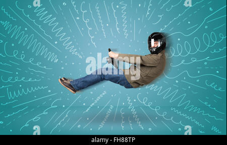 Funny guy drives an imaginary vehicle with drawn lines around him Stock Photo