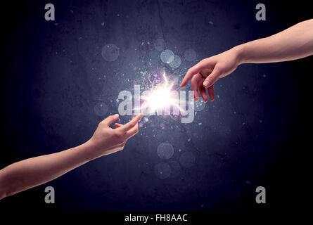 Hands reaching to light a spark Stock Photo