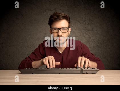 Computer geek typing on keyboard Stock Photo