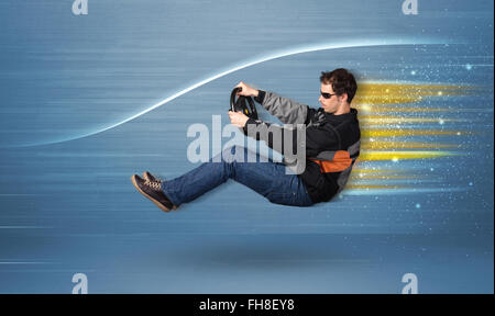 Young man driving in imaginary fast car with blurred lines Stock Photo