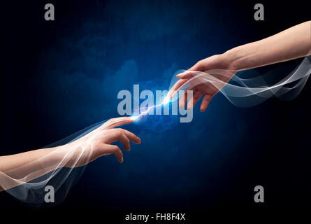 Hands connecting through fingers in space Stock Photo