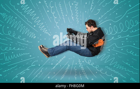 Funny guy drives an imaginary vehicle with drawn lines around him Stock Photo