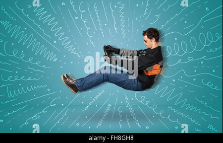 Funny guy drives an imaginary vehicle with drawn lines around him Stock Photo