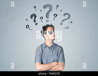 Young man with glued eye and question mark symbols Stock Photo