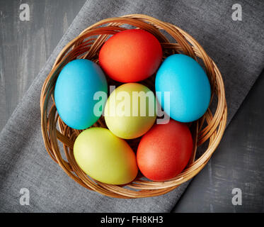 Easter eggs in a wicker basket, top view Stock Photo