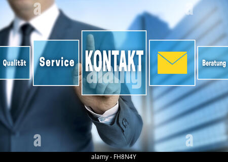 Contact (in german language Kontakt) touchscreen is operated by businessman. Stock Photo