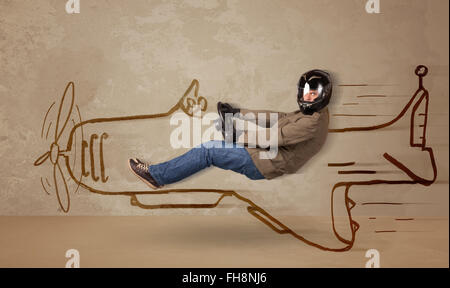 Funny pilot driving a hand drawn airplane on the wall Stock Photo