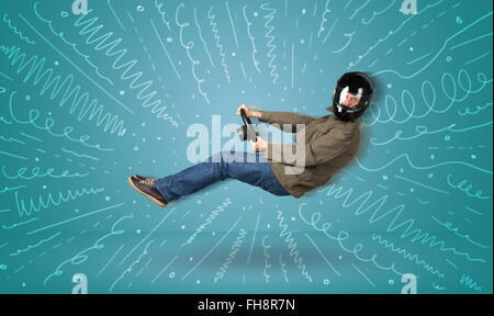 Funny guy drives an imaginary vehicle with drawn lines around him Stock Photo