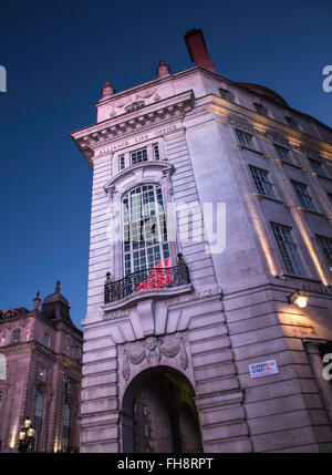 Twilight in Piccadilly Circus with Bright Lights from Iconic Signage Brightening Old Buildings Stock Photo