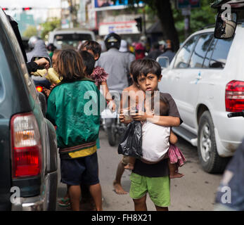 kids in street begging, Phnom Penh, Cambodia Stock Photo