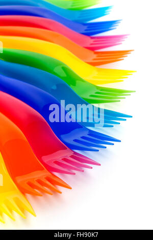 Rainbow colored plastic forks on white background Stock Photo