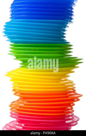 Rainbow colored plastic plates on white background Stock Photo