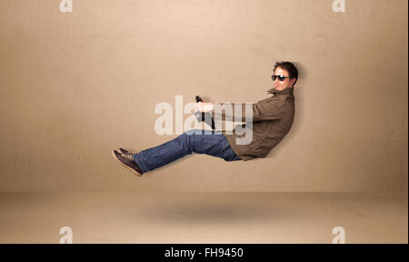 Happy funny man driving a flying car concept Stock Photo