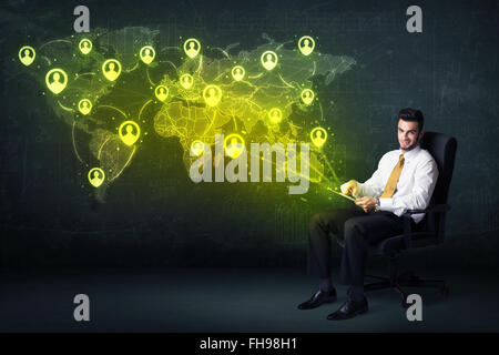 Businessman in office with tablet and social network world map Stock Photo