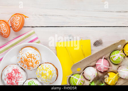 Easter with colorful eggs and traditional cakes over white wooden table. Top view with copy space Stock Photo