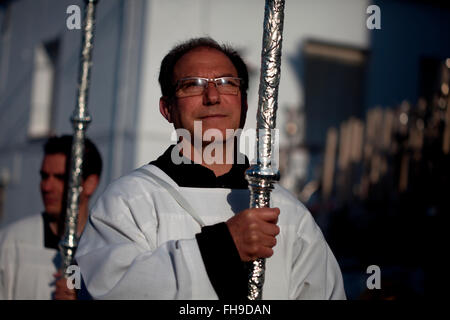 Altar boys hold candles during an Easter Holy Week procession in Prado del Rey, Andalusia, Spain Stock Photo