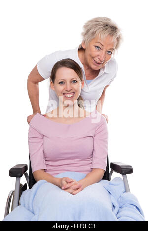 young woman in wheelchair, aged nurse behind her, isolated on white Stock Photo