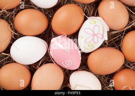 Easter eggs in straw nest. Top view Stock Photo