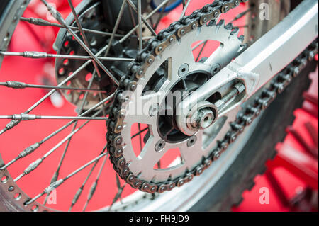 Rear chain of motorcycle on a red background Stock Photo