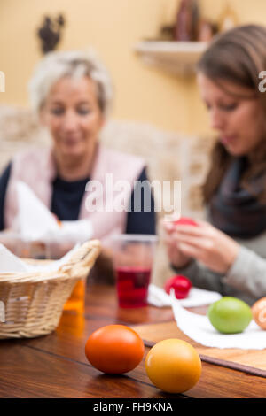 women painting easter eggs in the living room Stock Photo
