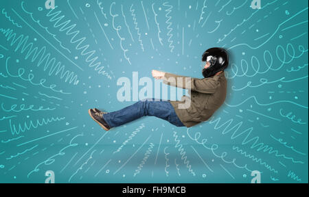 Funny guy drives an imaginary vehicle with drawn lines around him Stock Photo