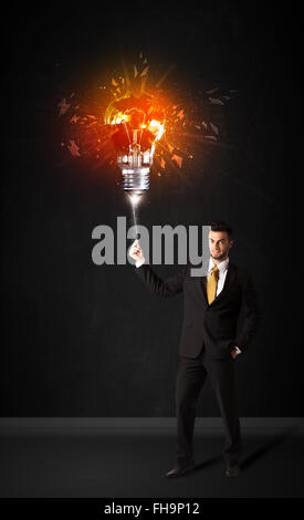 Businessman with an explosion bulb Stock Photo