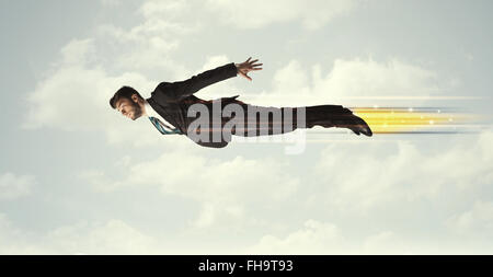 Happy business man flying fast on the sky between clouds Stock Photo