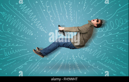 Funny guy drives an imaginary vehicle with drawn lines around him Stock Photo