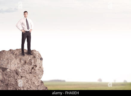 Happy salesman on cliff in the country Stock Photo