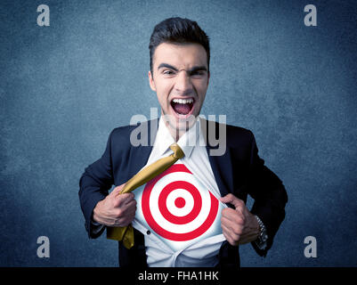 Businessman tearing shirt with target sign on his chest Stock Photo