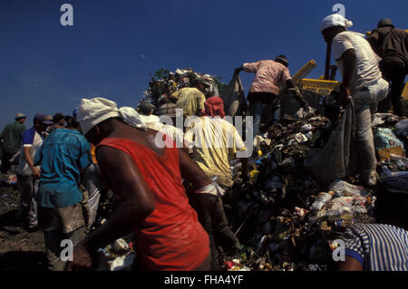 Pickers sort through garbage finding recyclables as a means of survival at Metropolitan Landfill of Jardim Gramacho (  Aterro Metropolitano de Jardim Gramacho ) in Duque de Caxias city, one of the largest landfills in the world, closed in June 2012 after 34 years of operation when it received most of the garbage produced in Rio de Janeiro city - it was started on an ecologically-sensitive wetland in the 1970s adjacent to Guanabara Bay. Stock Photo