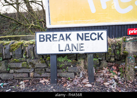Break Neck Lane road sign in front of low stone wall Stock Photo