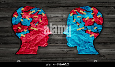 Thinking exchange and idea partnership business communication concept as a red and blue human head cut from crumpled paper sharing broken pieces as a creative collaboration symbol for understanding political opinions or cultural differences. Stock Photo