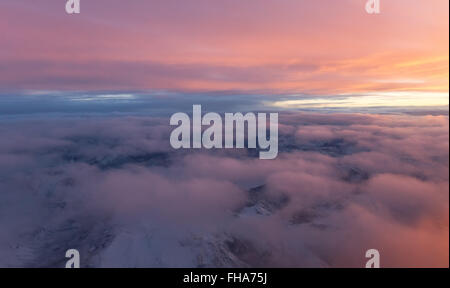 sunset viewed from an airplane over Canadian Rocky Mountains Stock Photo