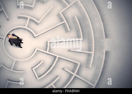 Business man trapped in a circular maze Stock Photo