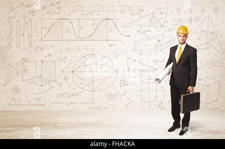 Handsome engineer calculating with hand drawn background Stock Photo