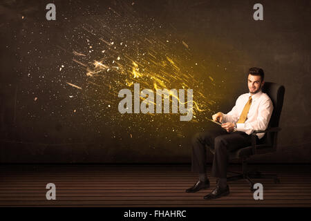 Businessman with tablet and energy explosion on background Stock Photo