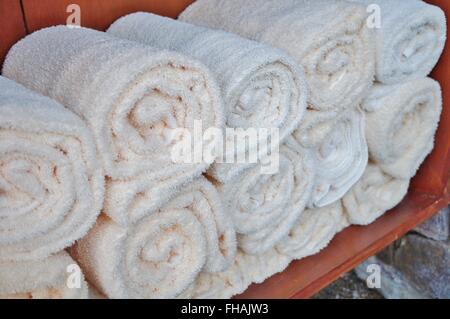 Rolled up white bath towels at the spa Stock Photo