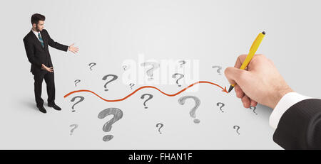 Business man looking at question marks and solution path Stock Photo